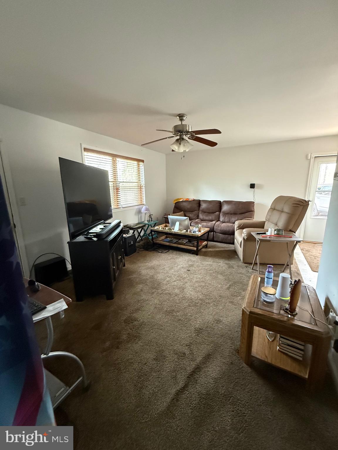 722 Oak Hill Road Berkeley Springs, WV 25411 - Photo 4 of 16 a living room with furniture a flat screen tv and gym equipment