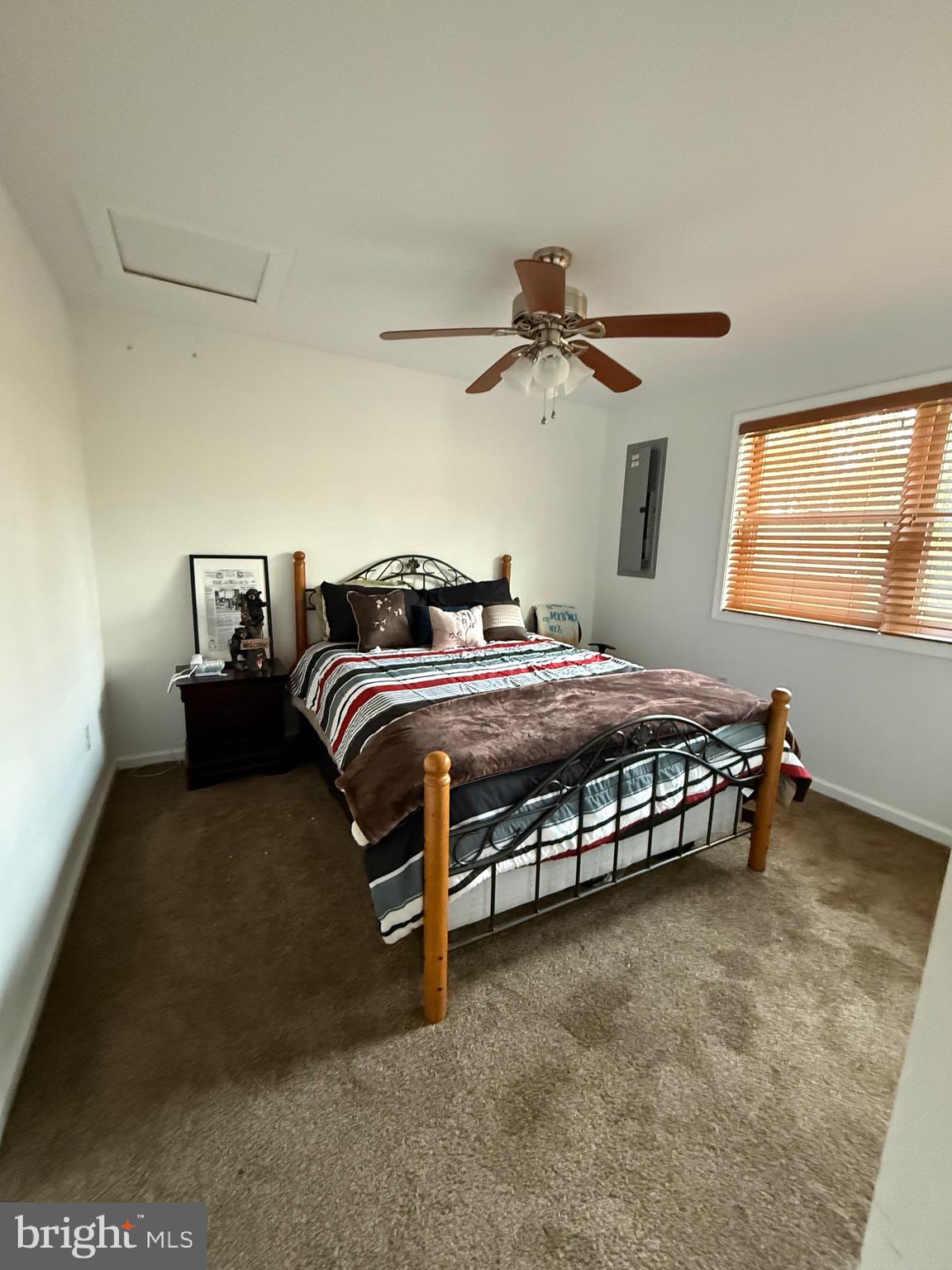 722 Oak Hill Road Berkeley Springs, WV 25411 - Photo 5 of 16 a bedroom with a bed and a ceiling fan