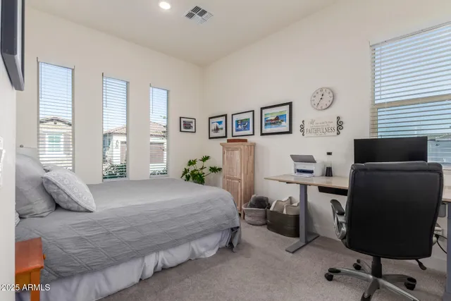 a bedroom with a bed and a desk