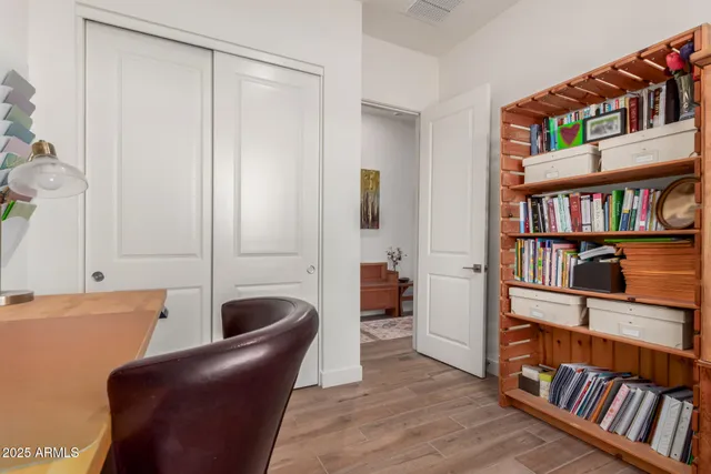 a living room with furniture and a book shelf