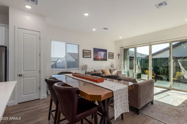 a dining hall with stainless steel appliances granite countertop a table and chairs