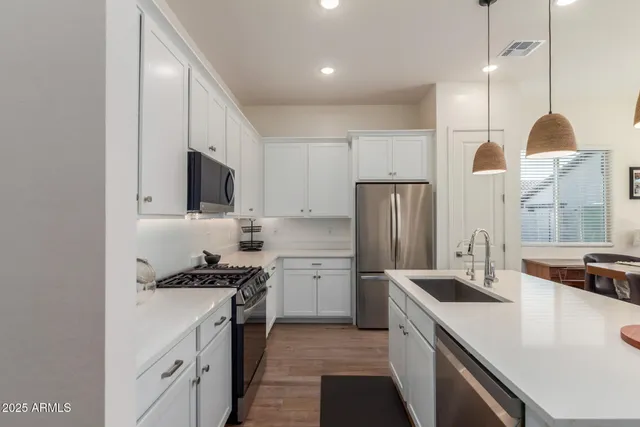 a kitchen with a sink a stove a refrigerator and island