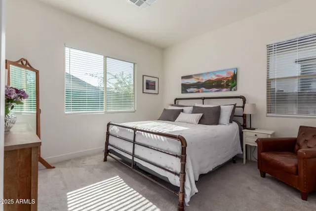 a bedroom with a bed couch and window