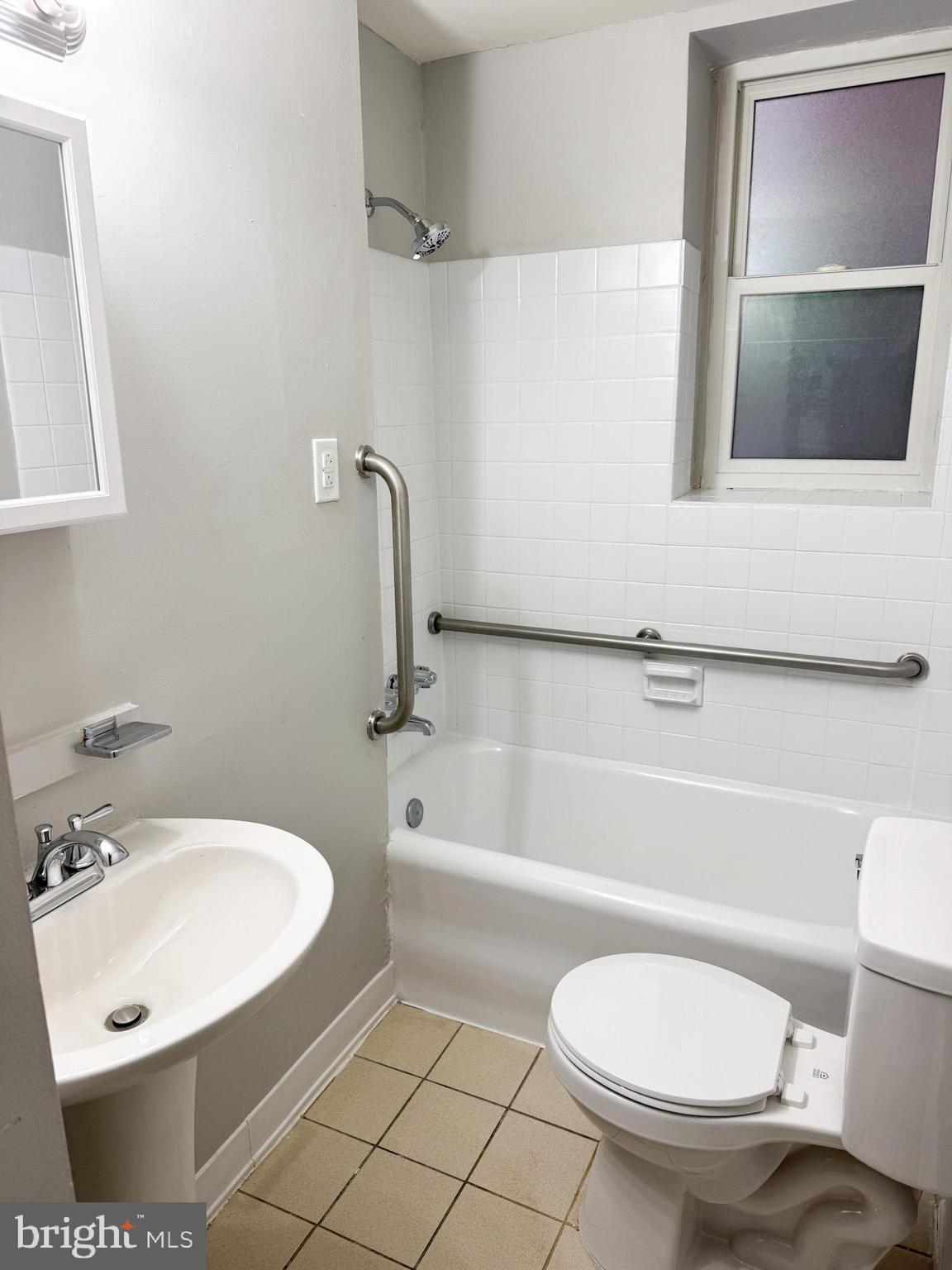 4715 Walnut Street, Unit 122 Philadelphia, PA 19139 - Photo 5 of 5 a bathroom with a sink toilet and shower