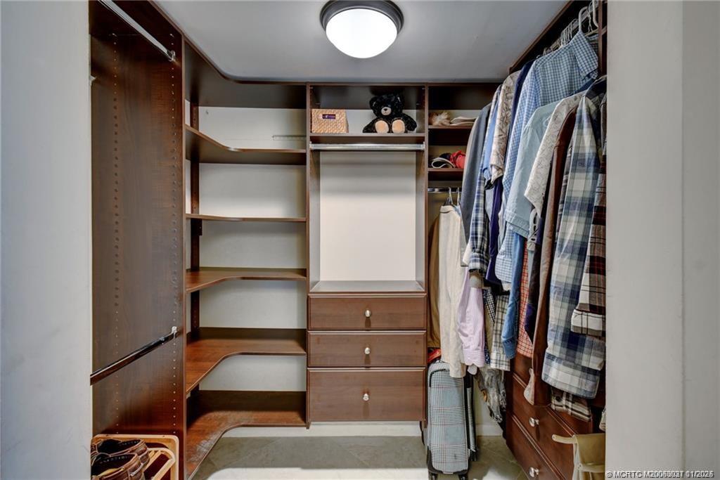 248 Northeast Edgewater Drive Stuart, FL 34996 - Photo 25 of 38 a view of walk in closet with clothes and shoes