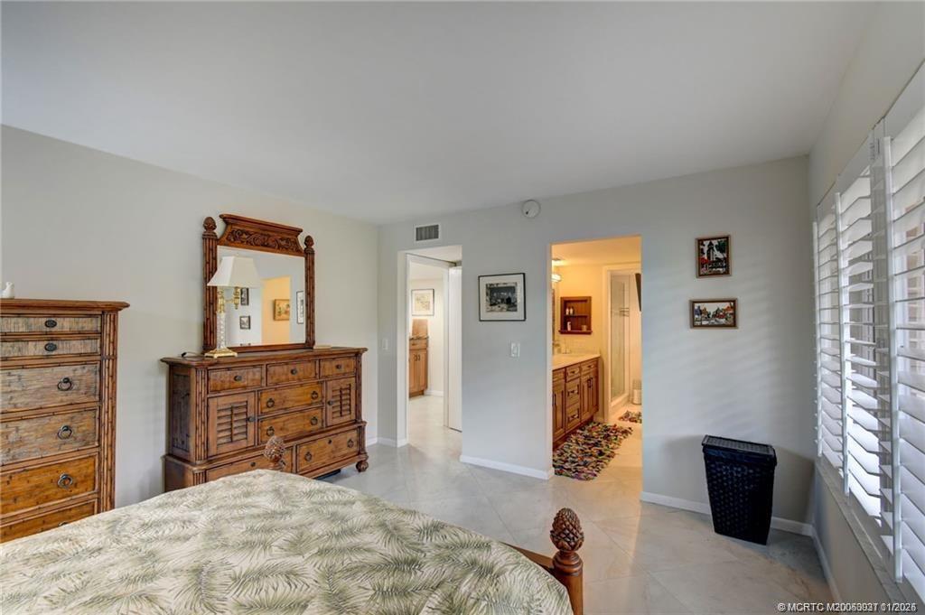 248 Northeast Edgewater Drive Stuart, FL 34996 - Photo 26 of 38 a bedroom with a bed and furniture