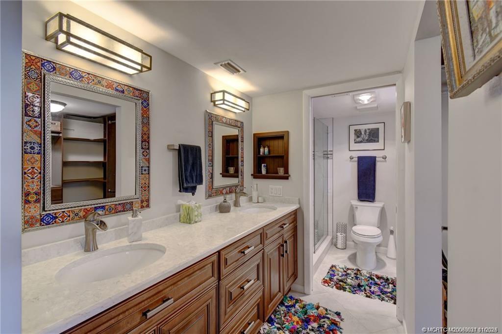 248 Northeast Edgewater Drive Stuart, FL 34996 - Photo 28 of 38 a bathroom with a sink double vanity and a toilet