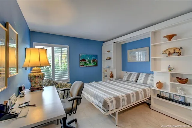 a bedroom with a bed and a desk