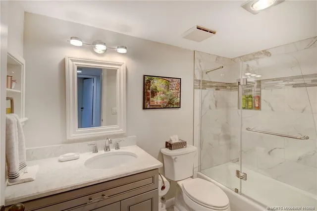 a bathroom with a sink toilet a mirror and shower