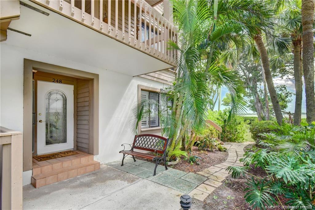 248 Northeast Edgewater Drive Stuart, FL 34996 - Photo 6 of 38 a bench sitting in front of a house