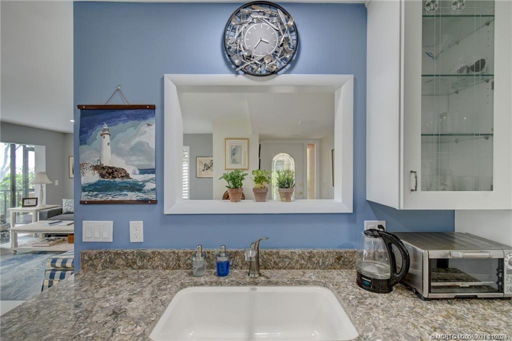 248 Northeast Edgewater Drive Stuart, FL 34996 - Photo 9 of 38 a bathroom with a sink and a mirror