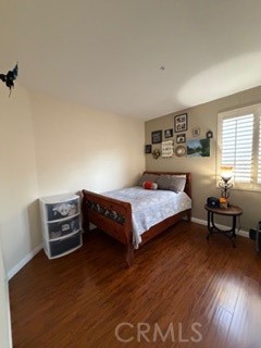 17416 Birchtree Street Fontana, CA 92337 - Photo 12 of 18 a bedroom with a bed and wooden floor
