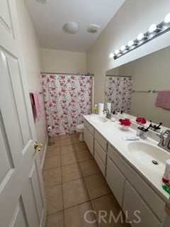 17416 Birchtree Street Fontana, CA 92337 - Photo 14 of 18 a bathroom with a sink mirror and shower