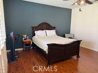 17416 Birchtree Street Fontana, CA 92337 - Photo 8 of 18 a bed sitting in a bedroom next to a window with wooden floor