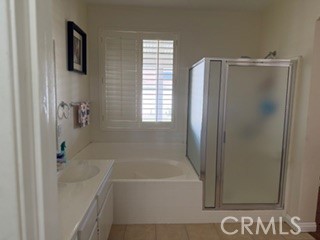 17416 Birchtree Street Fontana, CA 92337 - Photo 10 of 18 a bathroom with a bathtub and a shower