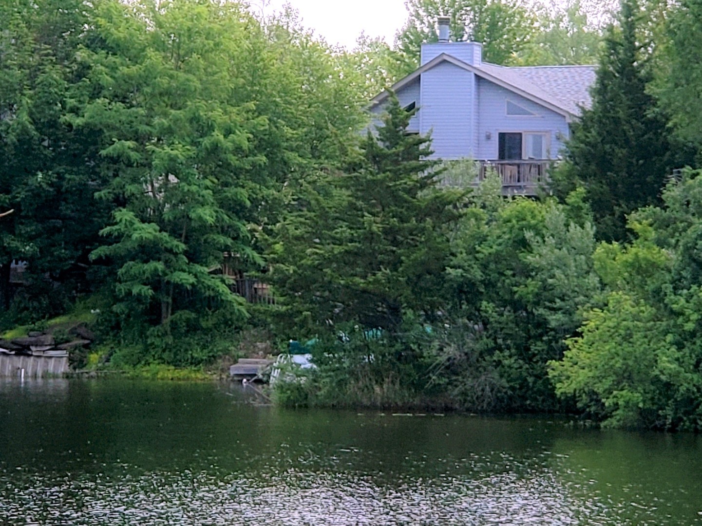 a view of a house with a yard and a pond