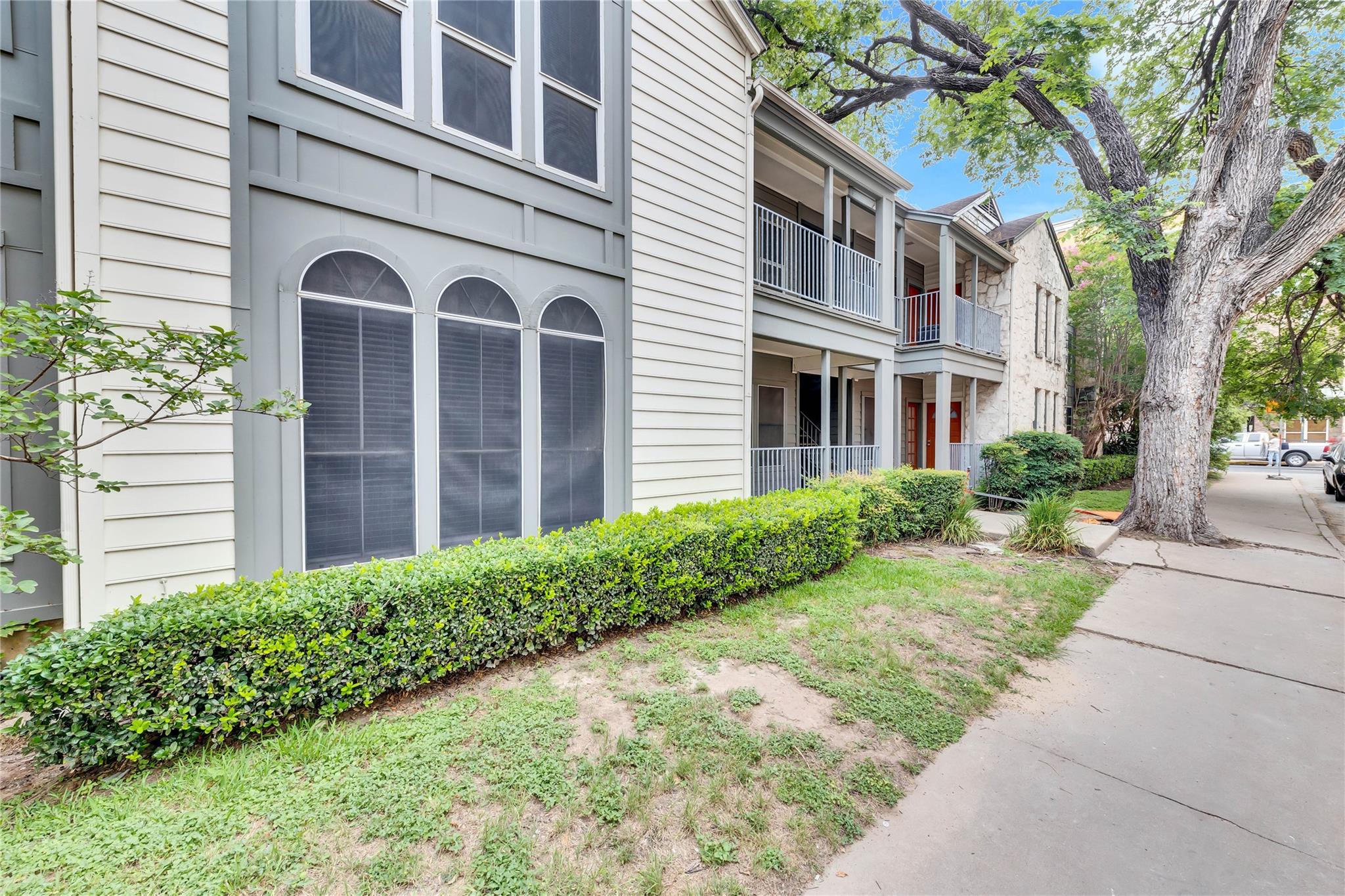 2529 Rio Grande Street, Unit 100 Austin, TX 78705 - Photo 5 of 14 a view of a brick building next to a yard