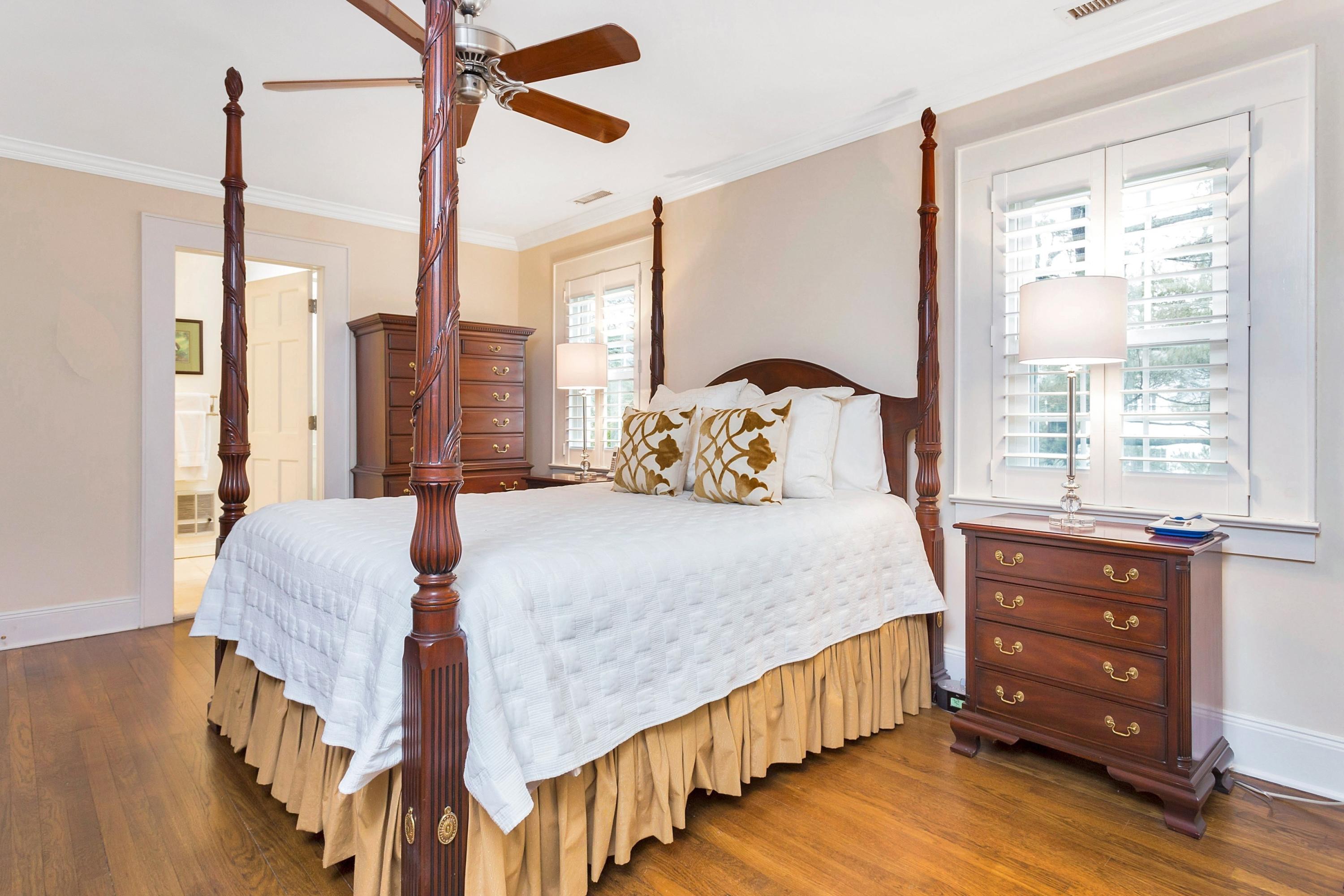 12 Dorchester Lane Riverside, CT 06878 - Photo 16 of 35 a bedroom with a bed window and a chandelier