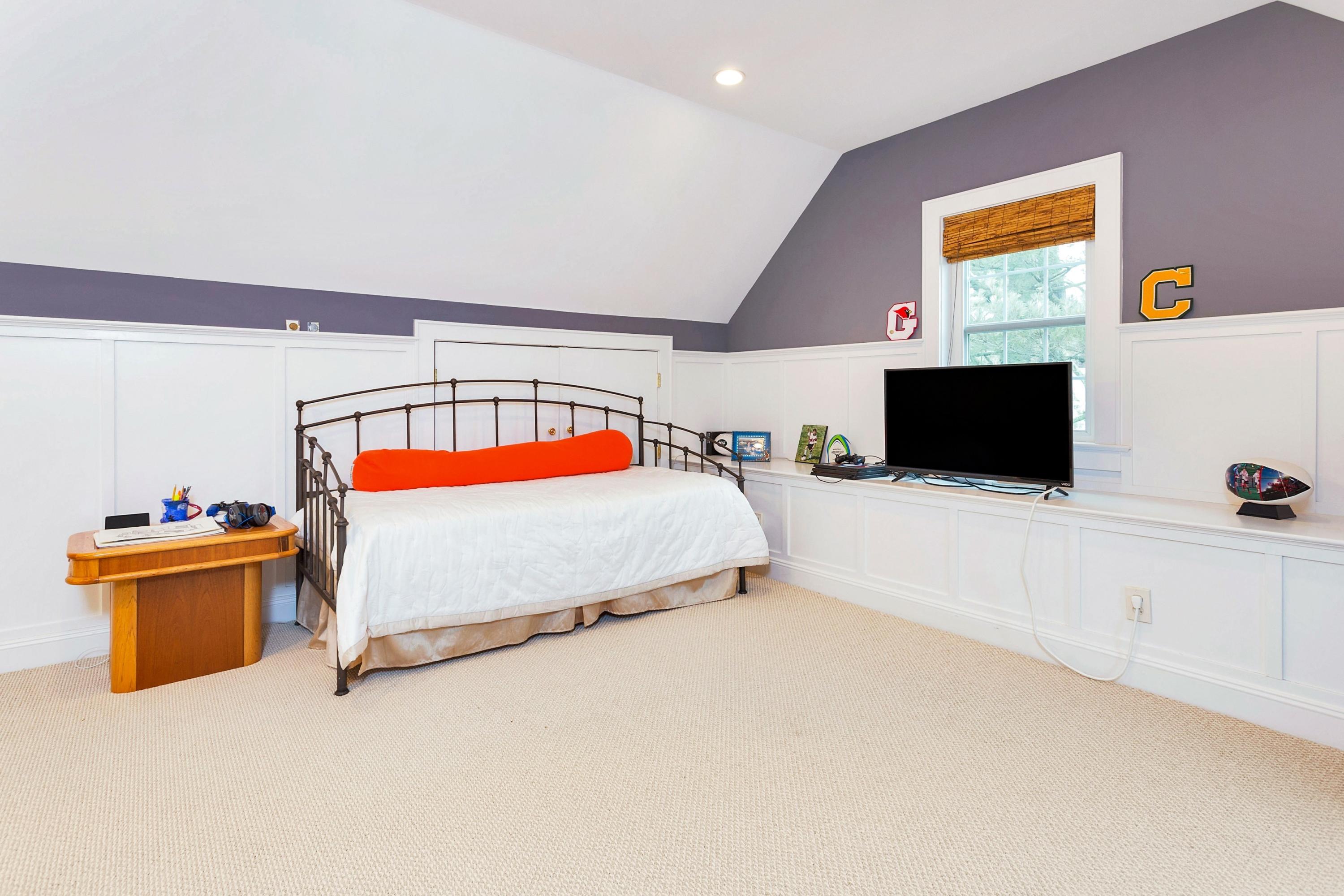 12 Dorchester Lane Riverside, CT 06878 - Photo 25 of 35 a bedroom with a bed and a flat screen tv