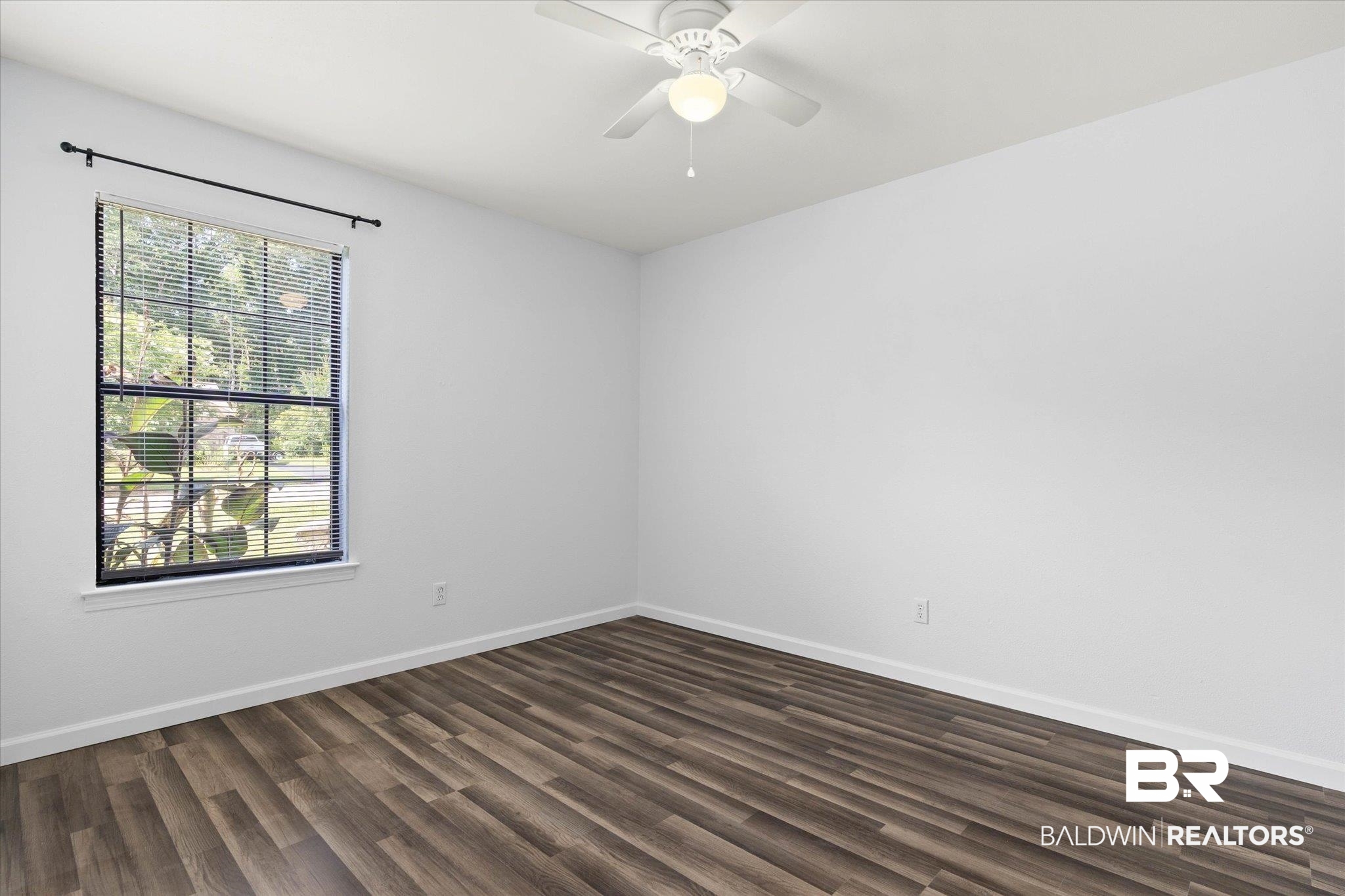 123 Richmond Road Daphne, AL 36526 - Photo 18 of 35 Empty room featuring dark wood-type flooring and a ceiling fan
