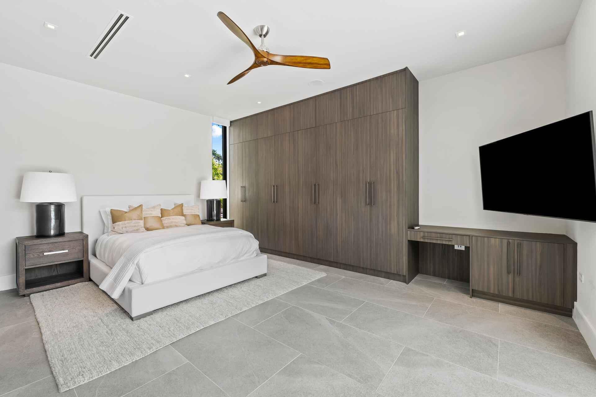 5288 Alton Road, Unit 3 Miami Beach, FL 33140 - Photo 14 of 33 a spacious bedroom with a bed and a flat screen television