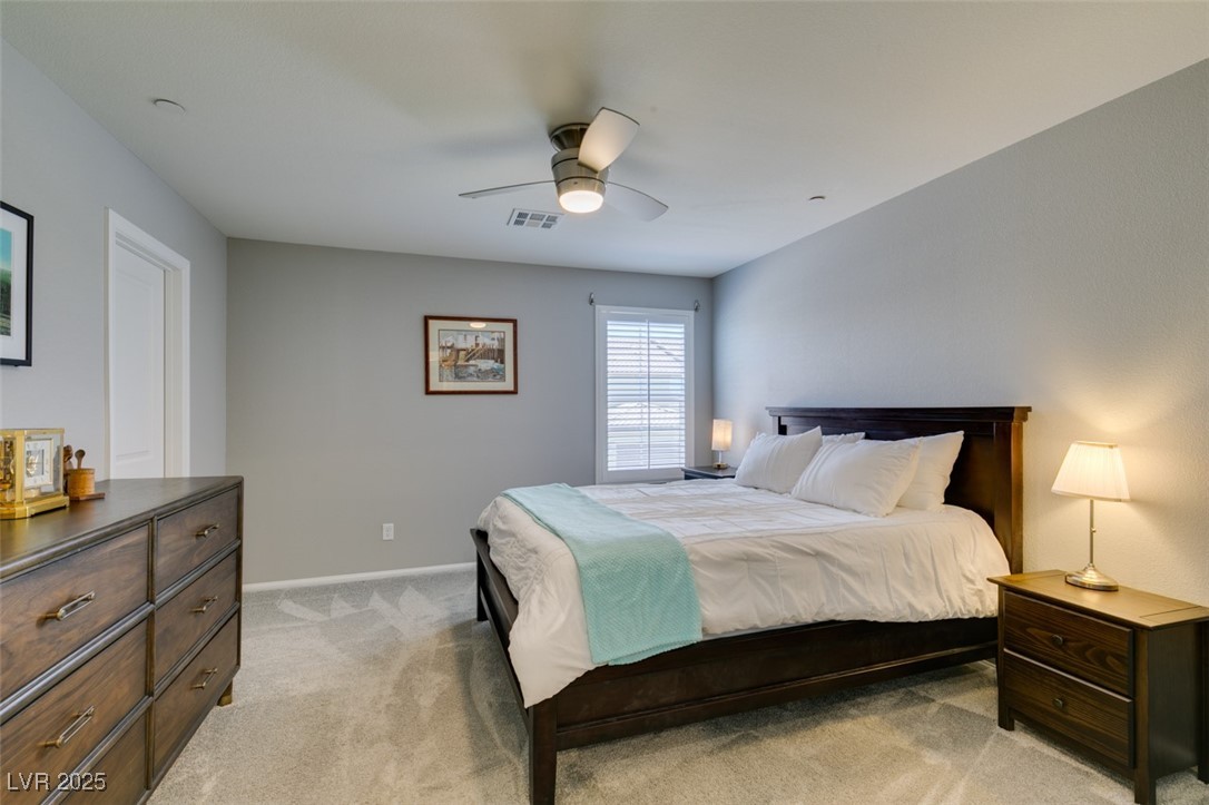 2870 Turnstone Ridge Street Henderson, NV 89044 - Photo 32 of 50 Bedroom with light colored carpet, baseboards, and ceiling fan
