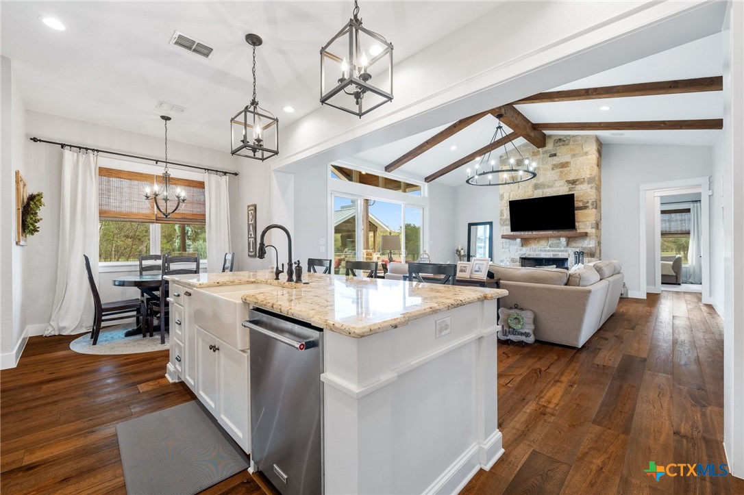1665 Sunflower Trail Luling, TX 78648 - Photo 14 of 46 a view of living room with kitchen island granite countertop furniture and fireplace