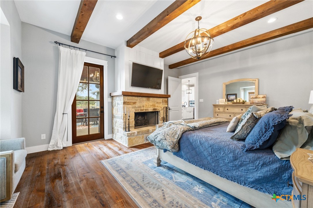 1665 Sunflower Trail Luling, TX 78648 - Photo 23 of 46 a spacious bedroom with a bed and a fireplace