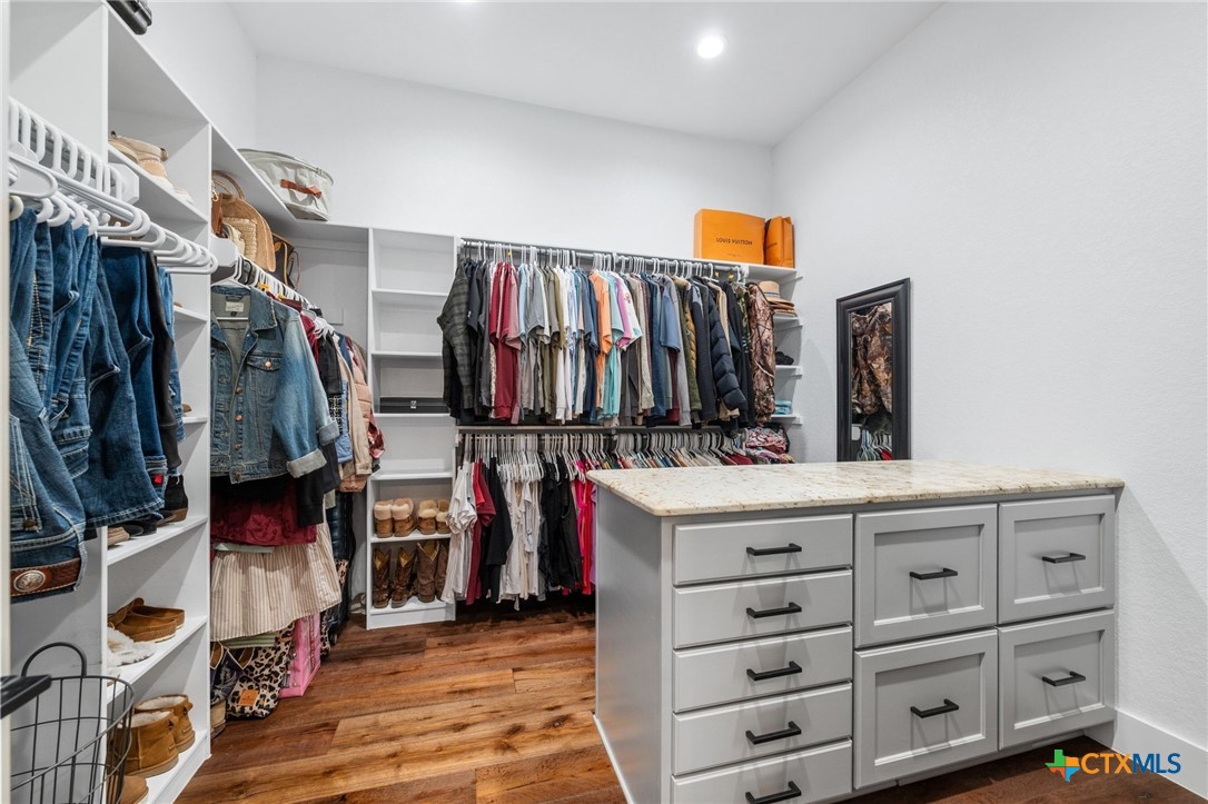 1665 Sunflower Trail Luling, TX 78648 - Photo 29 of 46 a view of walk in closet with clothes and shoes