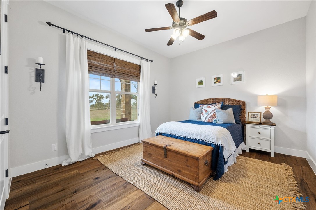 1665 Sunflower Trail Luling, TX 78648 - Photo 31 of 46 a bedroom with a bed and wooden floor