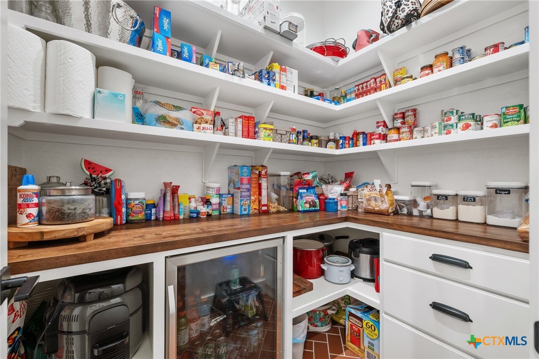 1665 Sunflower Trail Luling, TX 78648 - Photo 36 of 46 a utility room with stainless steel appliances lots of clutter