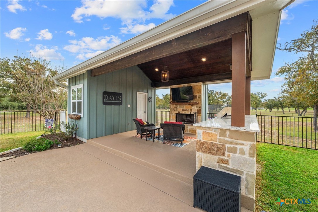 1665 Sunflower Trail Luling, TX 78648 - Photo 41 of 46 a view of a patio with table and chairs with wooden fence