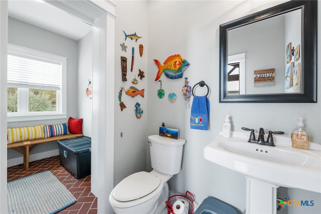 1665 Sunflower Trail Luling, TX 78648 - Photo 42 of 46 a bathroom with a toilet a sink and a mirror