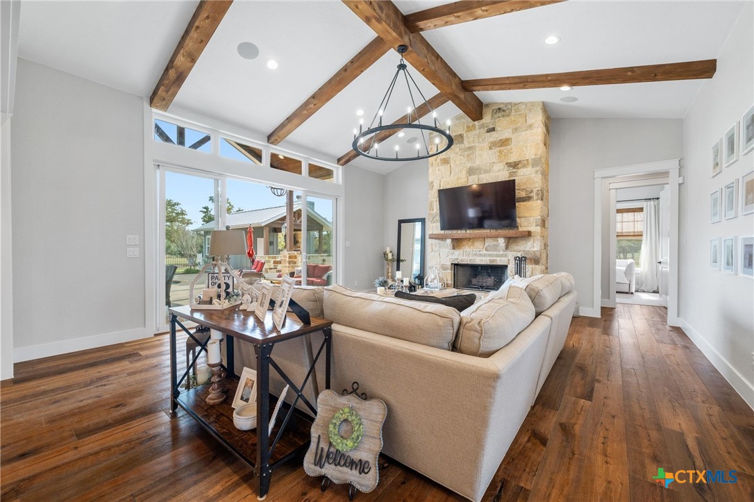 1665 Sunflower Trail Luling, TX 78648 - Photo 9 of 46 a living room with fireplace furniture and a wooden floor