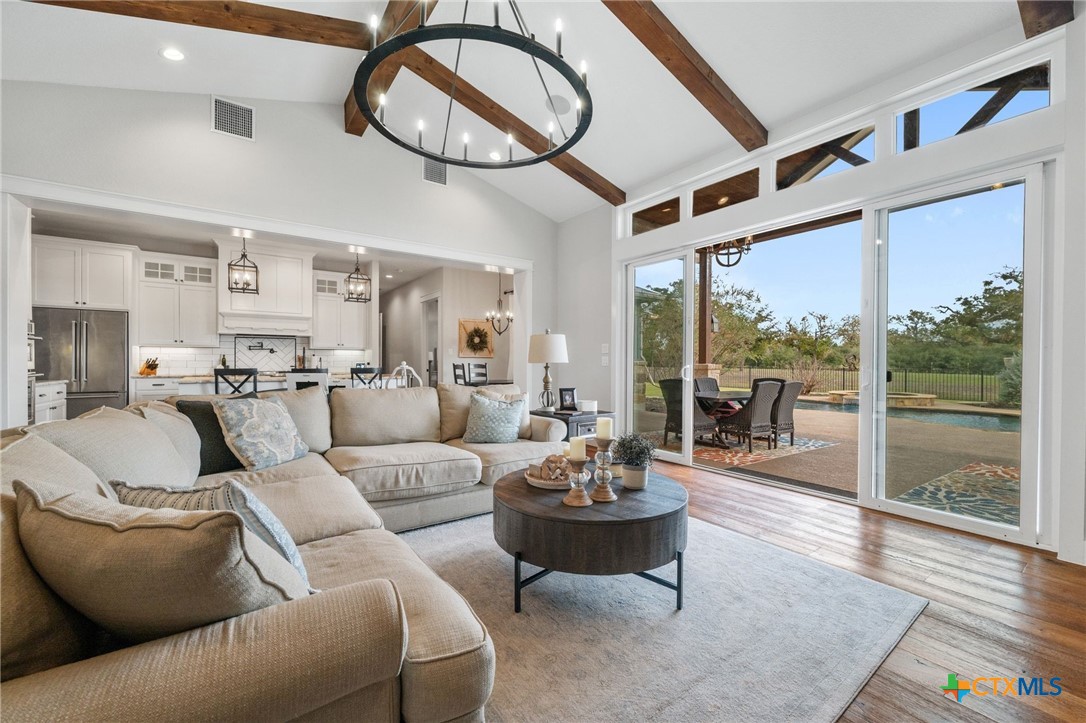 1665 Sunflower Trail Luling, TX 78648 - Photo 10 of 46 a living room with furniture a floor to ceiling window and wooden floor