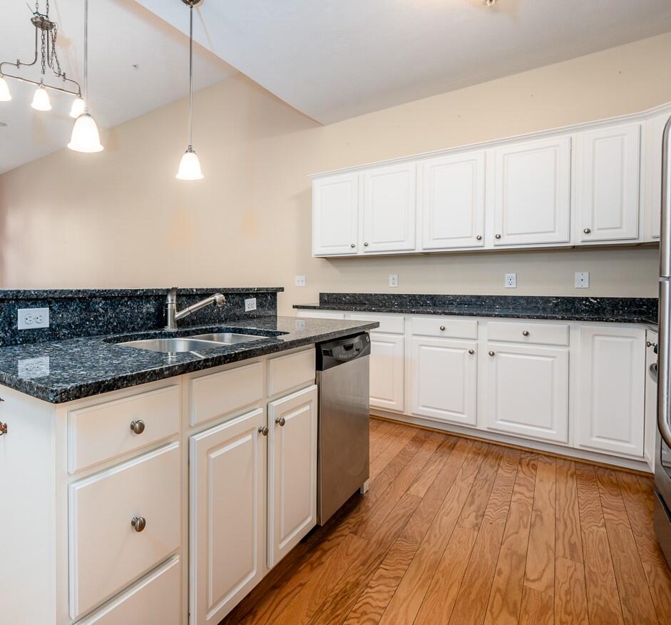 14 Chadwick Court Mashpee, MA 02649 - Photo 6 of 31 a kitchen with granite countertop white cabinets and white appliances