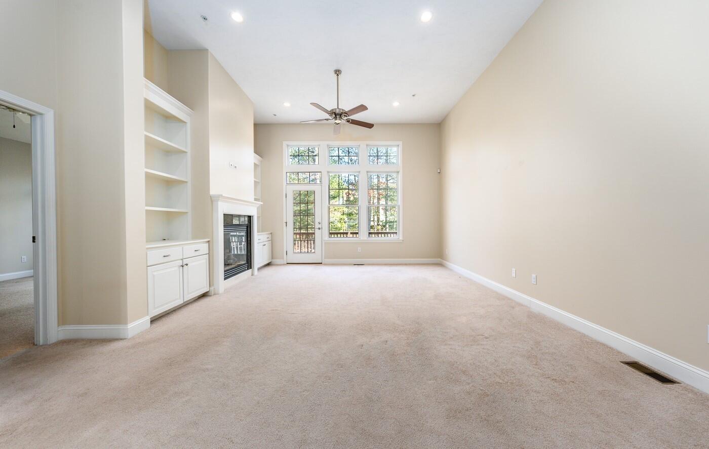 14 Chadwick Court Mashpee, MA 02649 - Photo 8 of 31 en empty room with windows and chandelier