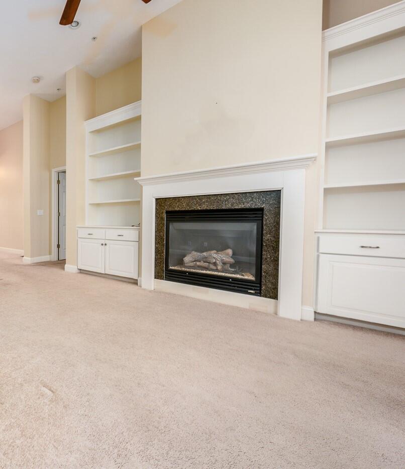14 Chadwick Court Mashpee, MA 02649 - Photo 9 of 31 a view of an empty room with a fireplace and a window