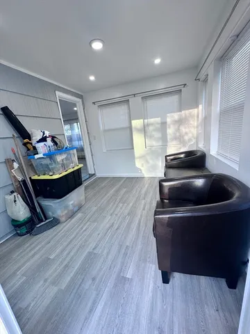 a view of a yard with lawn chairs fire pit and wooden fence