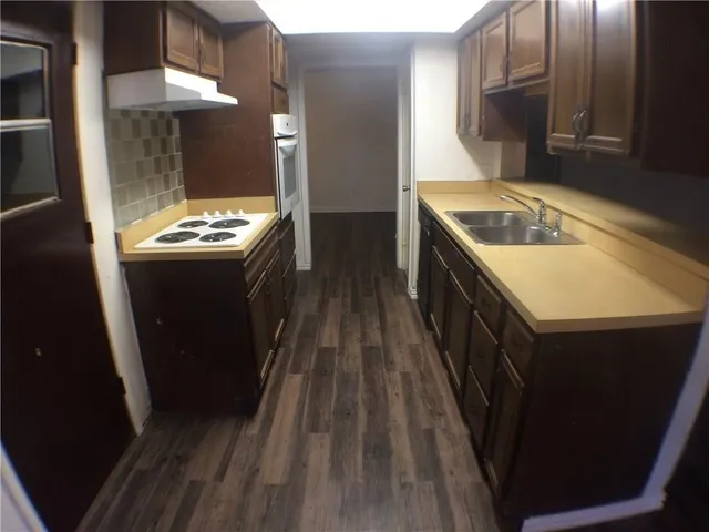 a kitchen with a sink stove and cabinets