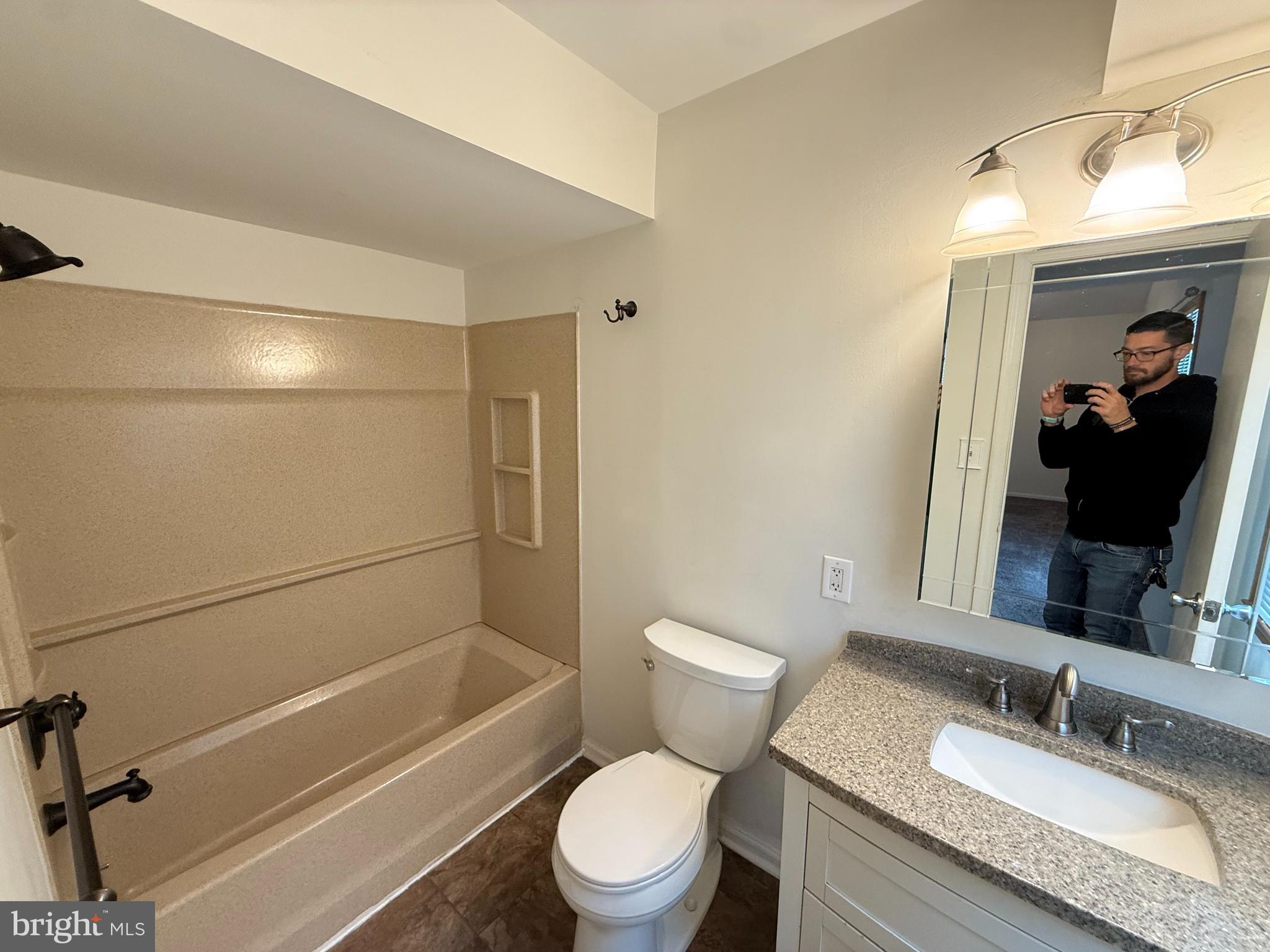 339 Georgia Court Sewell, NJ 08080 - Photo 4 of 12 a bathroom with a granite countertop toilet sink and a mirror