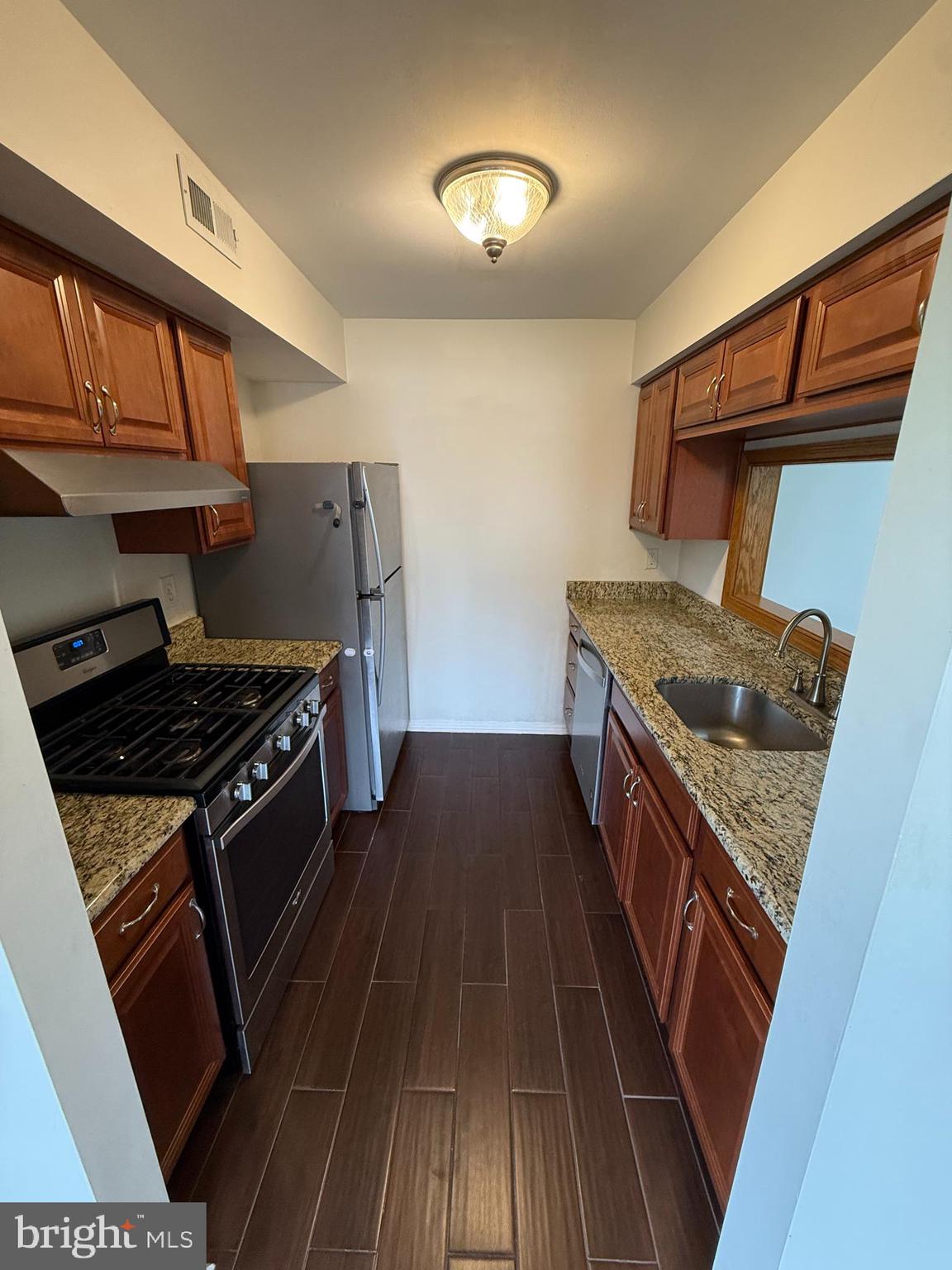 339 Georgia Court Sewell, NJ 08080 - Photo 10 of 12 a kitchen with wooden floors and a stove
