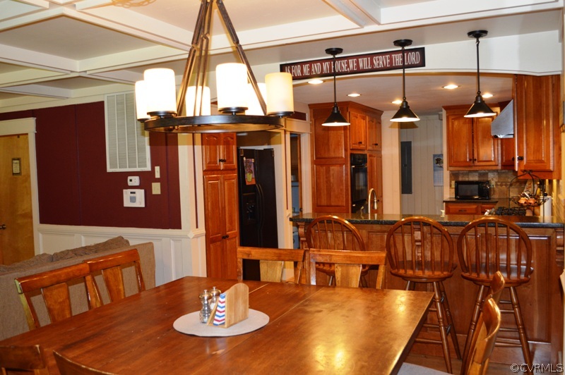 17216 Hamilton Arms Road Dewitt, VA 23840 - Photo 12 of 24 a view of a dining room with furniture and chandelier