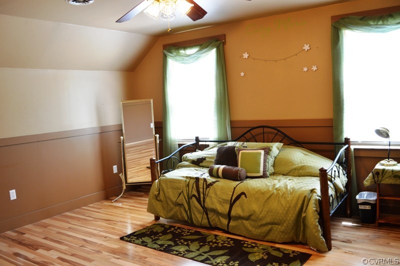 17216 Hamilton Arms Road Dewitt, VA 23840 - Photo 16 of 24 a bedroom with a bed and wooden floor
