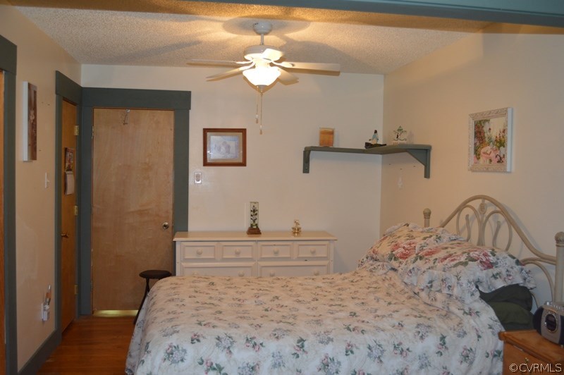 17216 Hamilton Arms Road Dewitt, VA 23840 - Photo 18 of 24 a bedroom with a bed and a chandelier