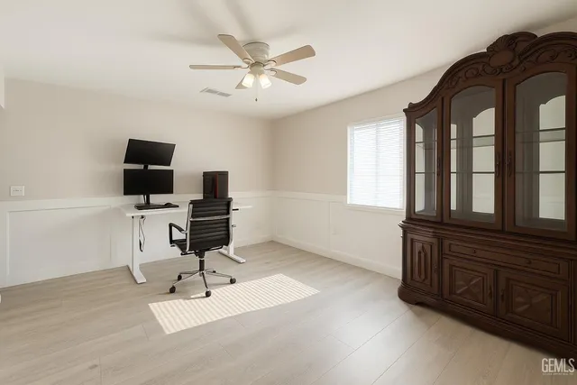 a view of a livingroom with workspace and a window