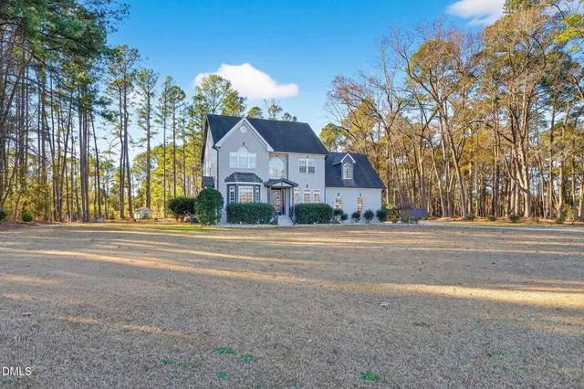 a living room with furniture a flat screen tv and a large window
