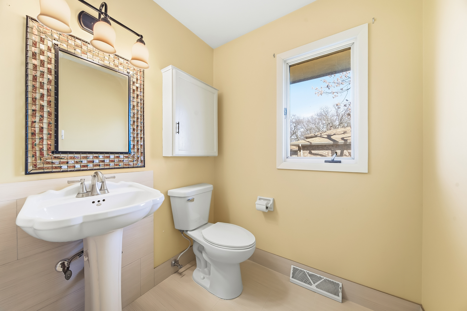 18317 Harper Street Lansing, IL 60438 - Photo 15 of 26 a bathroom with a toilet sink and mirror