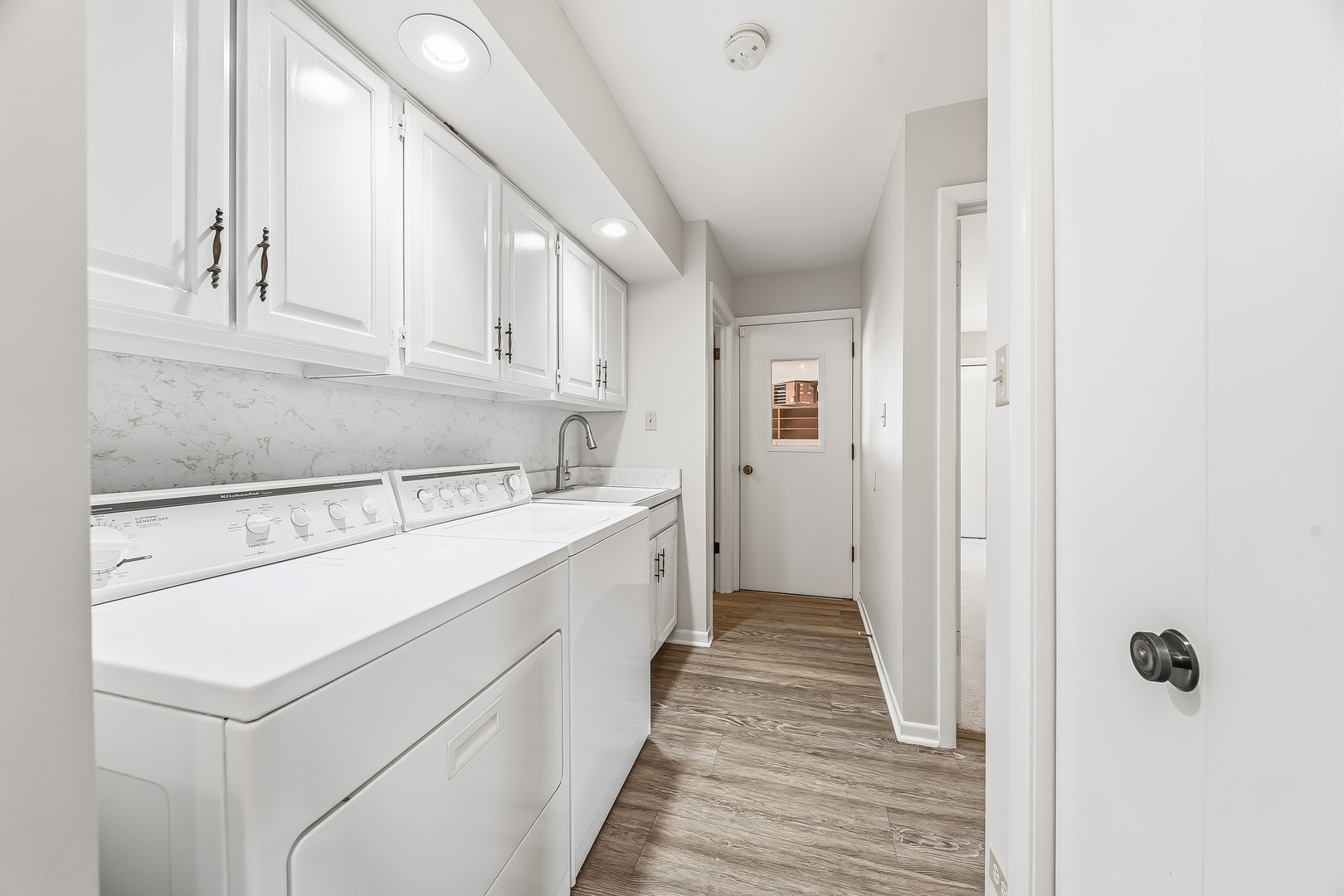 18317 Harper Street Lansing, IL 60438 - Photo 20 of 26 a kitchen with a sink and cabinets