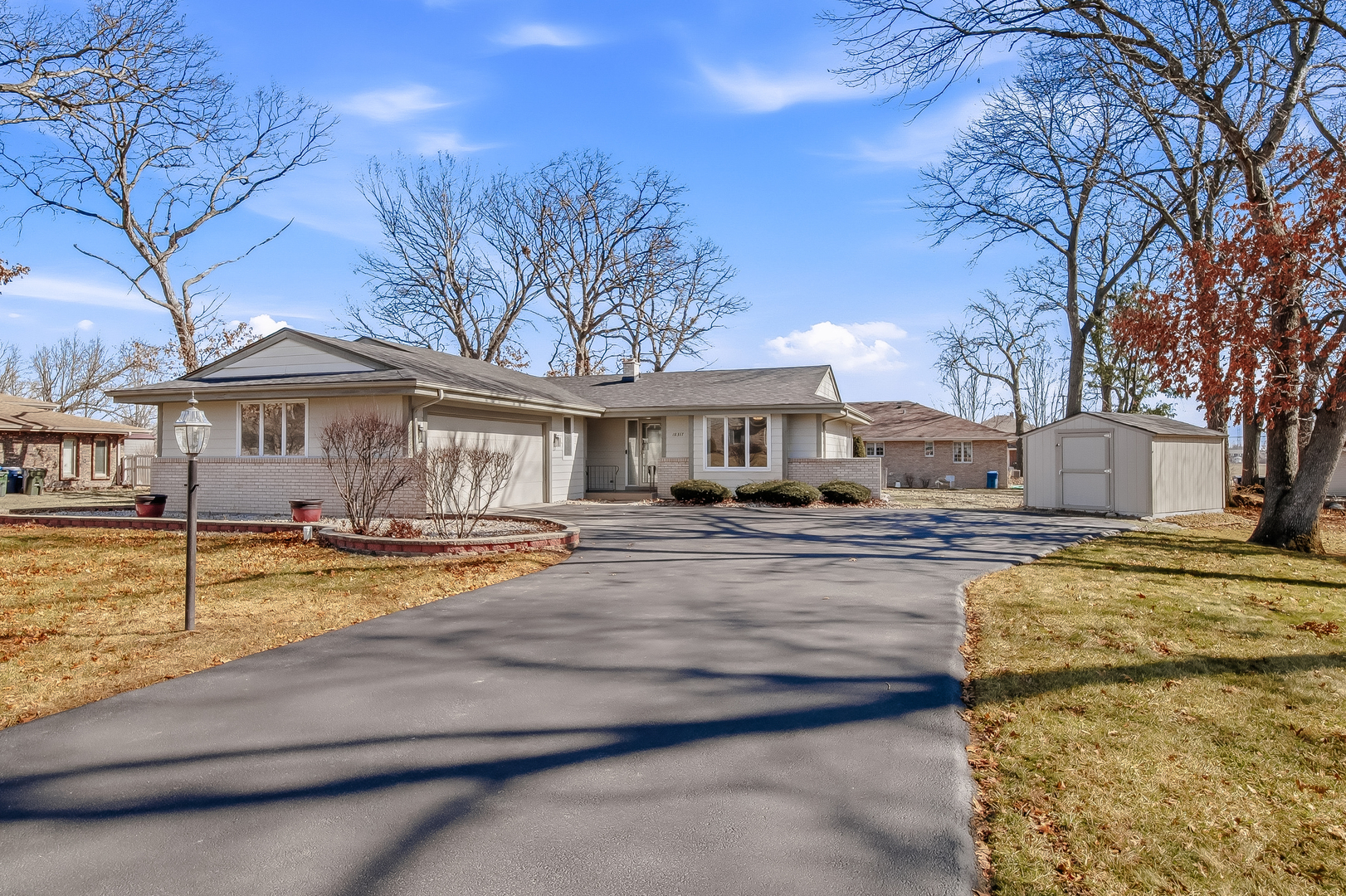 18317 Harper Street Lansing, IL 60438 - Photo 2 of 26 a view of a house with cars park next to a yard